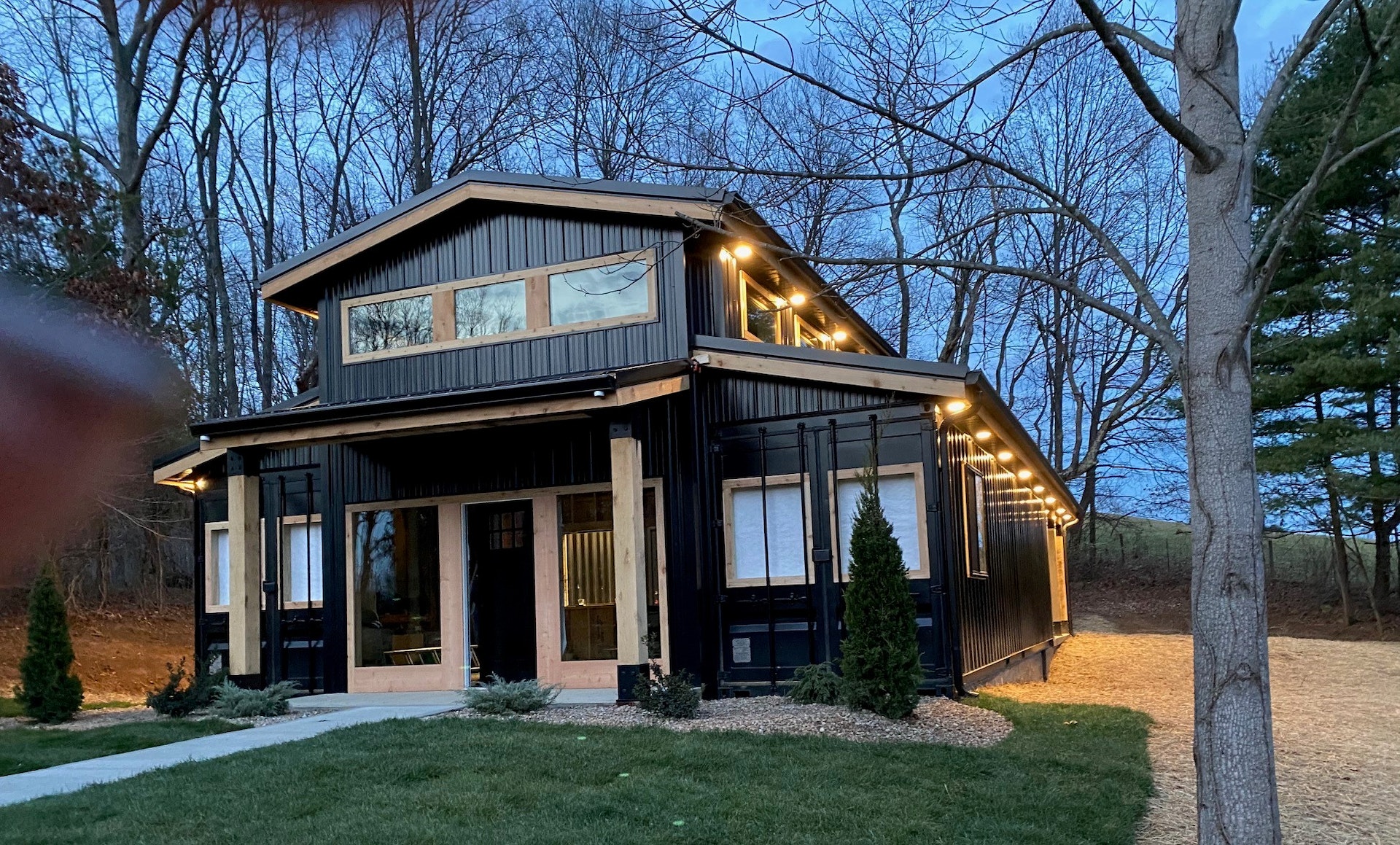 Exterior view at night of shipping container home